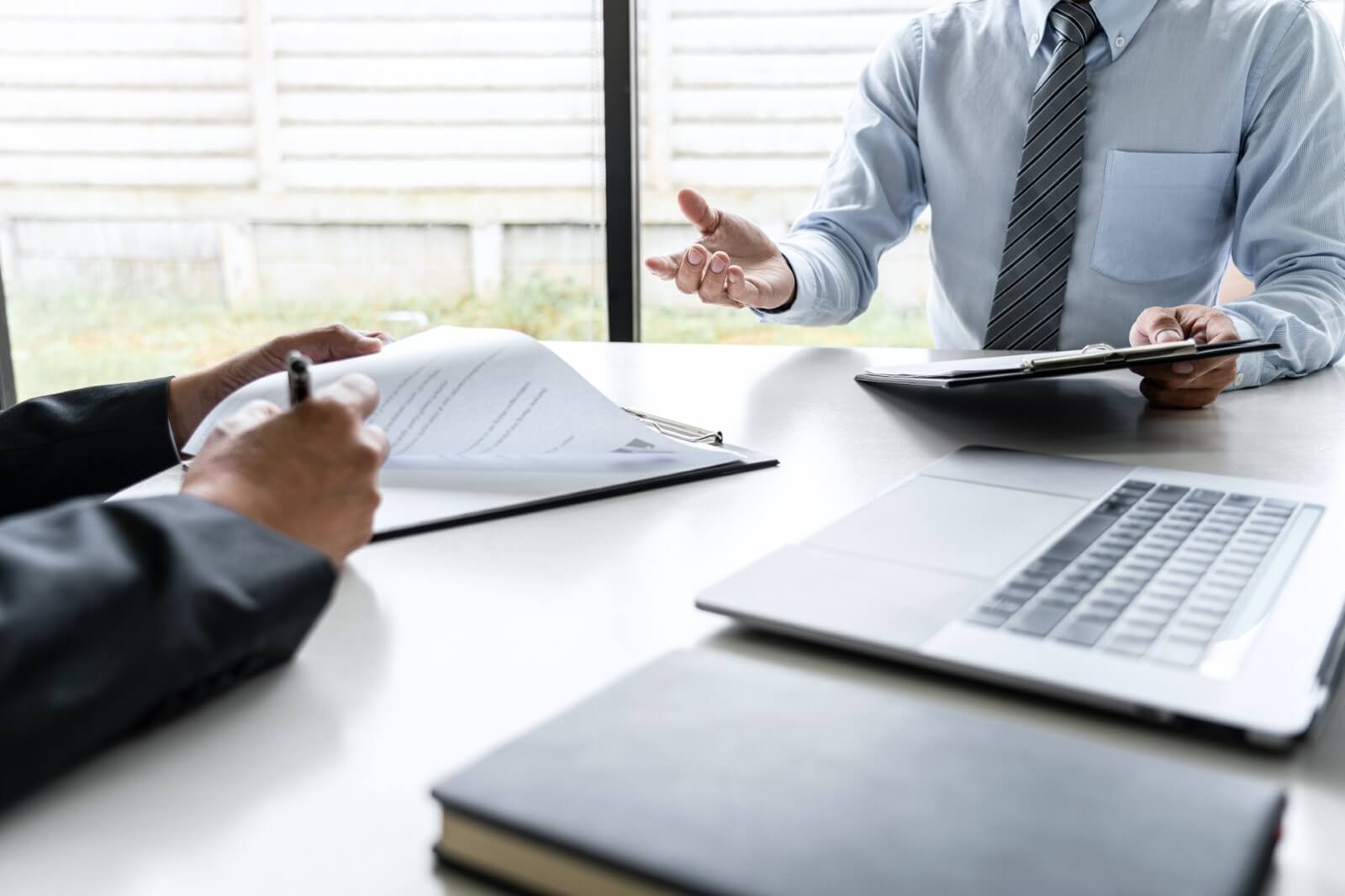 Consultation between CPA and IT advisor reviewing compliance checklist