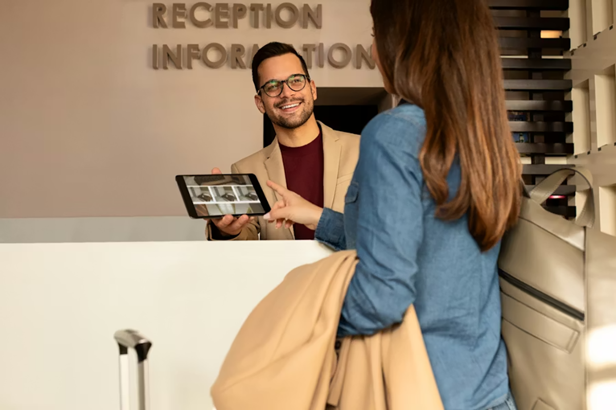 Luxury Los Angeles hotel front desk with secure payment systems and monitored Wi‑Fi illustrating cloud security in hospitality.